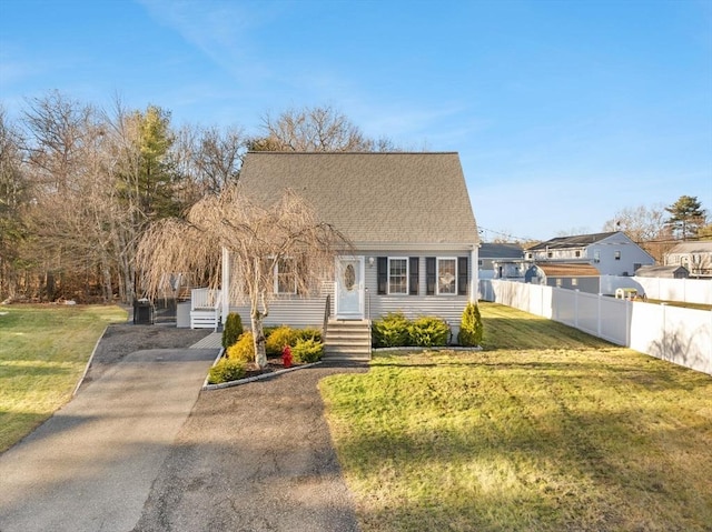 cape cod home with a front lawn