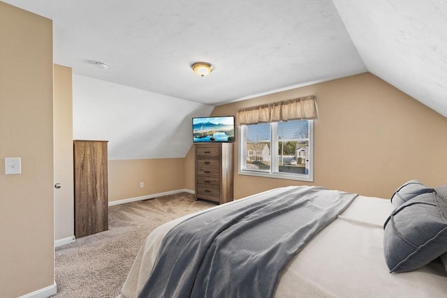 carpeted bedroom featuring vaulted ceiling