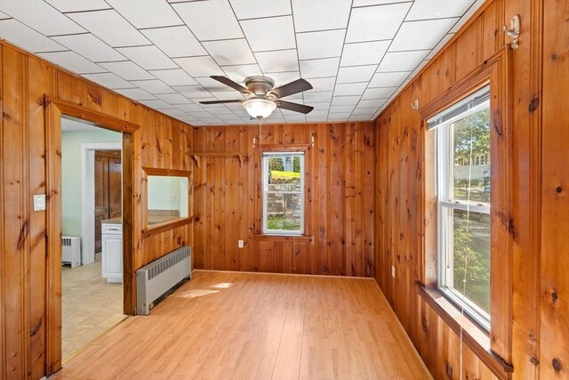 49 Bay View Dr, Shrewsbury, MA 01545 - empty room featuring radiator, healthy amount of natural light, a ceiling fan, and wooden walls