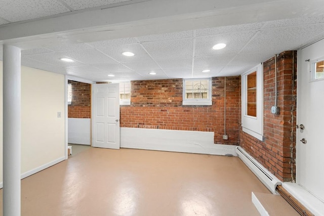49 Bay View Dr, Shrewsbury, MA 01545 - below grade area with brick wall, baseboard heating, a drop ceiling, recessed lighting, and baseboards