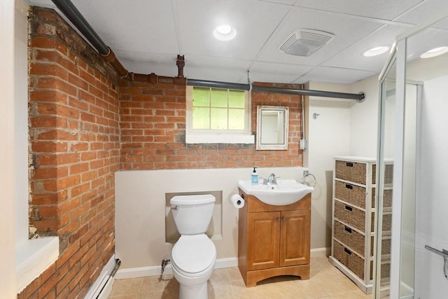 49 Bay View Dr, Shrewsbury, MA 01545 - bathroom featuring vanity, brick wall, tile patterned floors, toilet, and a stall shower