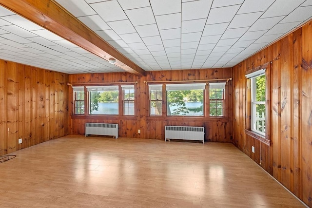49 Bay View Dr, Shrewsbury, MA 01545 - unfurnished room featuring radiator, plenty of natural light, wood walls, and light wood finished floors