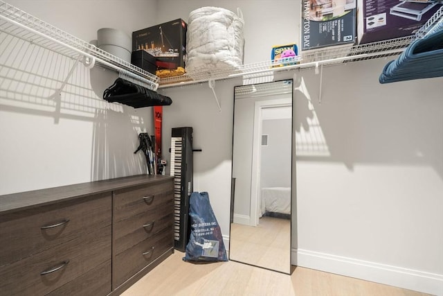 spacious closet featuring light hardwood / wood-style flooring