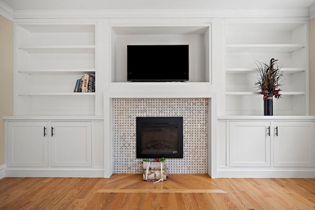 11 Broadway St Unit 2, Stoneham, MA 02180 - detailed view of built in shelves, wood finished floors, and a glass covered fireplace