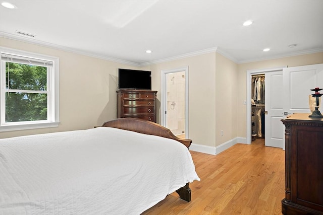 11 Broadway St Unit 2, Stoneham, MA 02180 - bedroom featuring recessed lighting, light wood finished floors, a spacious closet, ornamental molding, and connected bathroom