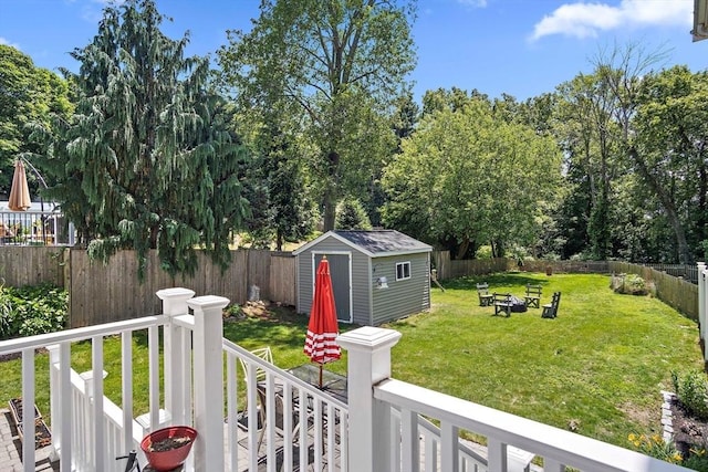 11 Broadway St Unit 2, Stoneham, MA 02180 - fenced backyard with an outdoor fire pit, a storage shed, and view of wooded area