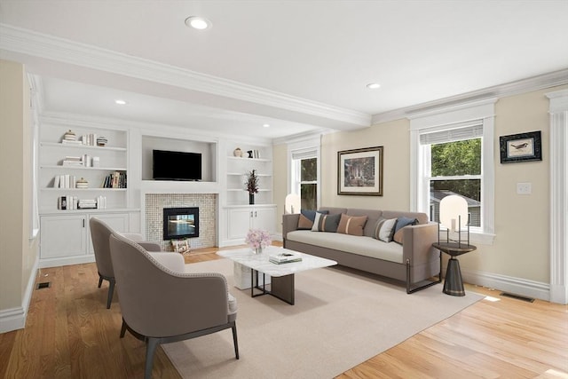 11 Broadway St Unit 2, Stoneham, MA 02180 - living room with a brick fireplace, crown molding, light wood-style flooring, and recessed lighting