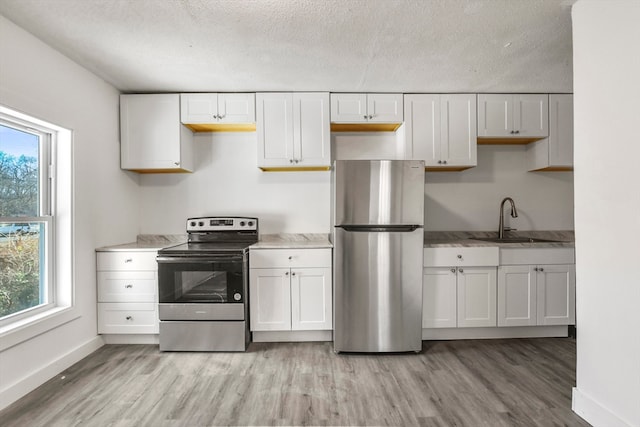 kitchen featuring sink, stainless steel appliances, and white cabinets