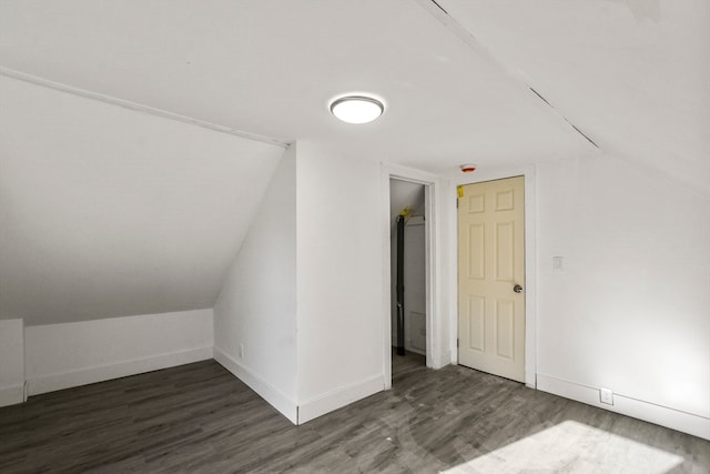 bonus room featuring dark wood-type flooring and vaulted ceiling