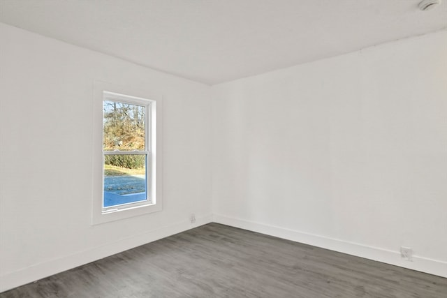 unfurnished room with dark hardwood / wood-style floors