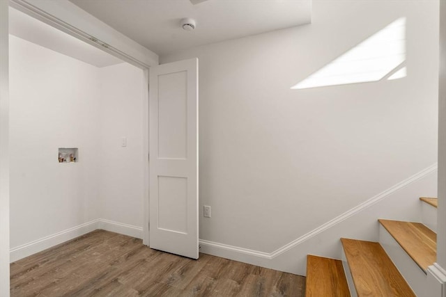 clothes washing area with hardwood / wood-style flooring and washer hookup