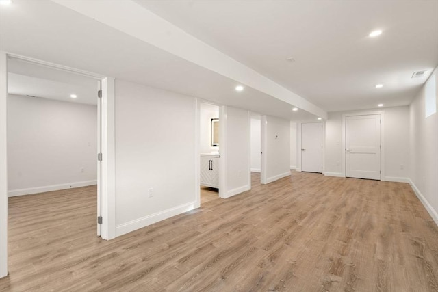 basement with light hardwood / wood-style floors