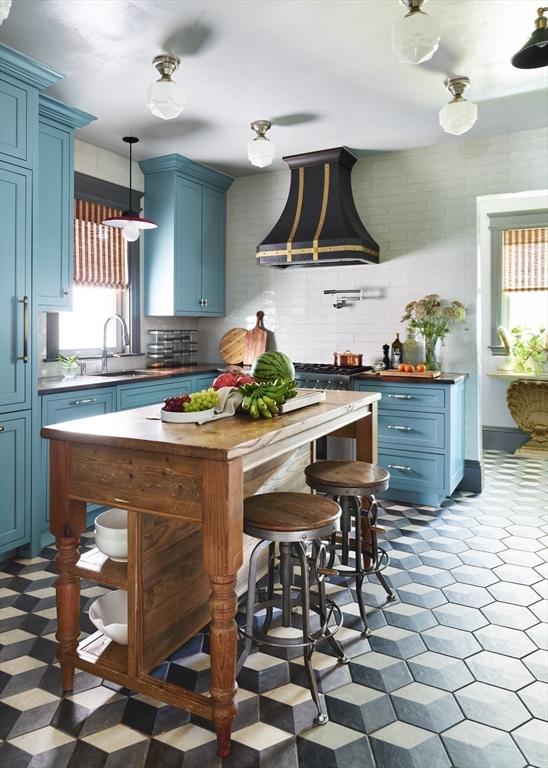 kitchen with blue cabinetry, custom exhaust hood, and tile patterned floors