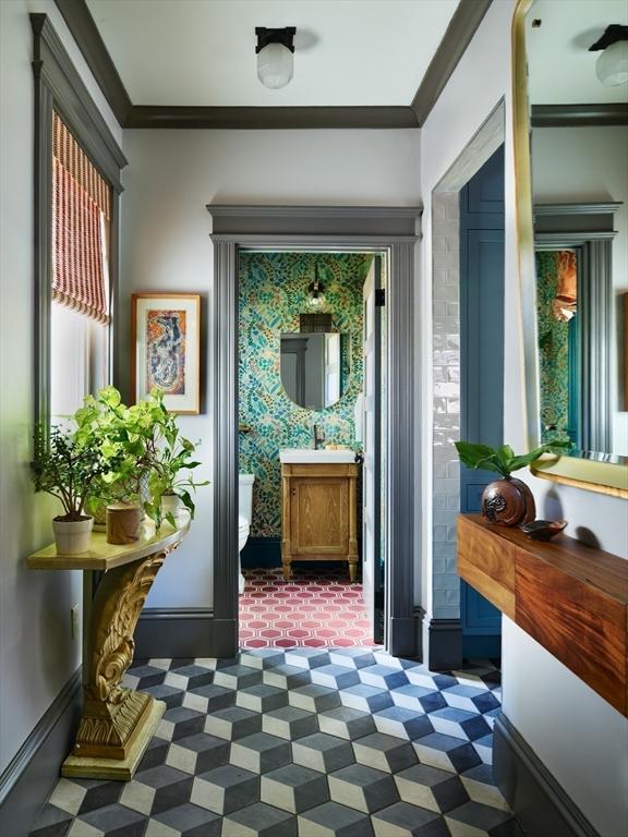 entryway with ornamental molding and tile patterned floors