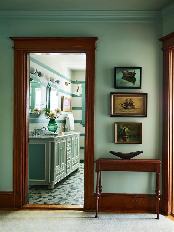 doorway with carpet floors and ornamental molding