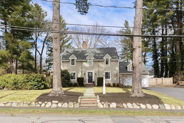 cape cod house featuring a chimney, driveway, and fence