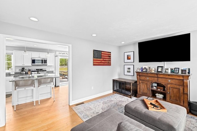 111 Spruce St, Middleboro, MA 02346 - living room featuring light wood-type flooring, recessed lighting, and baseboards