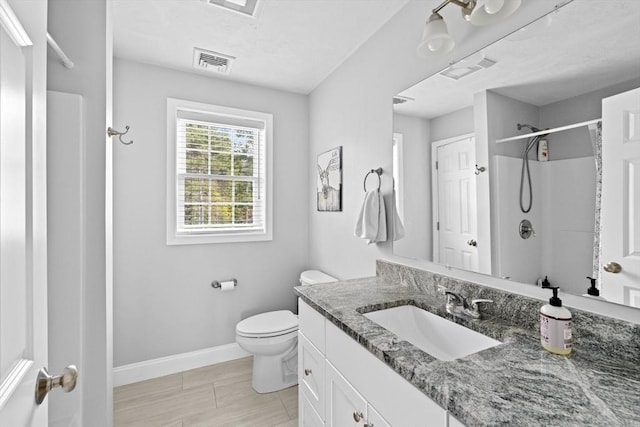 111 Spruce St, Middleboro, MA 02346 - full bathroom with vanity, toilet, a shower, and baseboards
