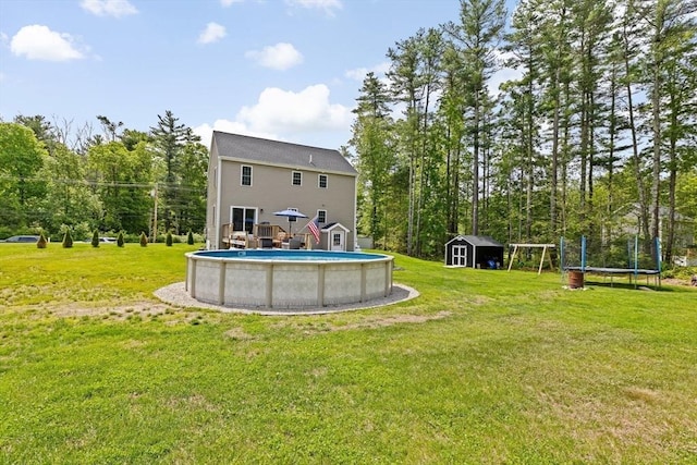 111 Spruce St, Middleboro, MA 02346 - back of house featuring a trampoline, an outdoor pool, and a yard