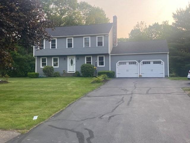 4 Erin Ln, Norfolk, MA 02056 - colonial-style house featuring an attached garage, a chimney, driveway, and a front lawn