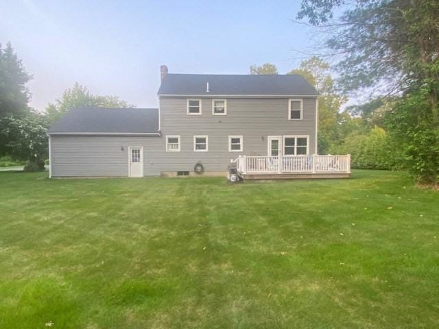 4 Erin Ln, Norfolk, MA 02056 - rear view of house with a wooden deck, a lawn, and a chimney