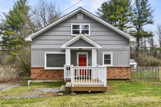 41 Bryant St, Pittsfield, MA 01201 - view of front of home featuring fence, a front lawn, and brick siding