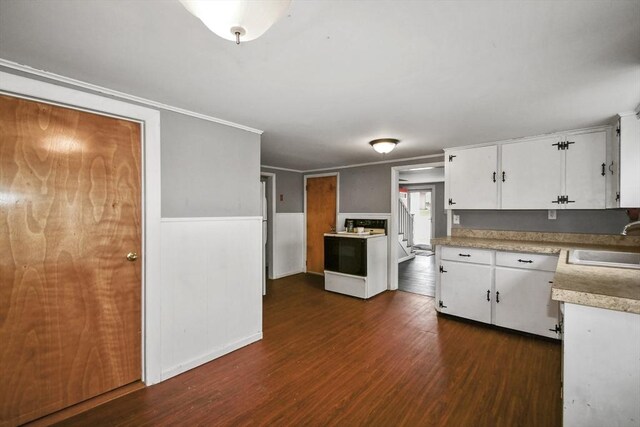 41 Bryant St, Pittsfield, MA 01201 - kitchen with electric stove, a sink, light countertops, white cabinets, and dark wood finished floors