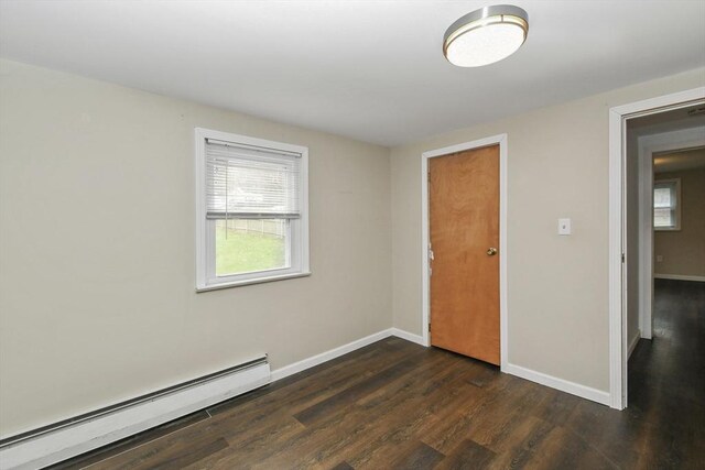 41 Bryant St, Pittsfield, MA 01201 - spare room with a baseboard radiator, a healthy amount of sunlight, dark wood-style floors, and baseboards