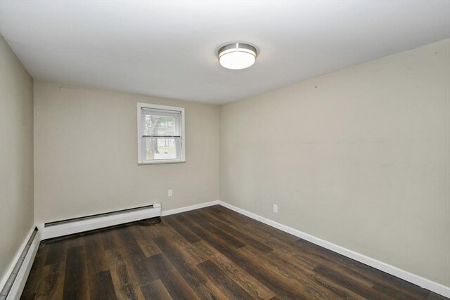 41 Bryant St, Pittsfield, MA 01201 - spare room featuring baseboards, dark wood finished floors, baseboard heating, and a baseboard radiator