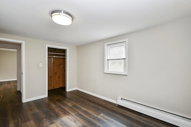 41 Bryant St, Pittsfield, MA 01201 - unfurnished bedroom with dark wood-type flooring, a closet, a baseboard heating unit, and baseboards