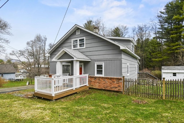 41 Bryant St, Pittsfield, MA 01201 - view of front of house with a deck, a front lawn, fence, and brick siding