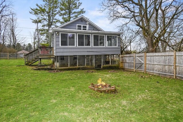 41 Bryant St, Pittsfield, MA 01201 - rear view of house featuring a deck, an outdoor fire pit, a sunroom, stairway, and a fenced backyard