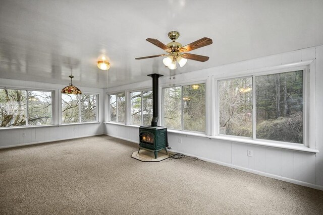 41 Bryant St, Pittsfield, MA 01201 - unfurnished sunroom featuring a wood stove, a wealth of natural light, and carpet floors