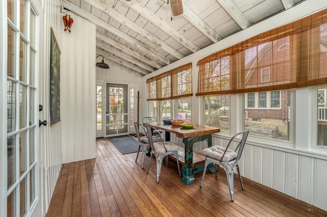 sunroom / solarium featuring wood-type flooring, lofted ceiling with beams, wood ceiling, and a deck