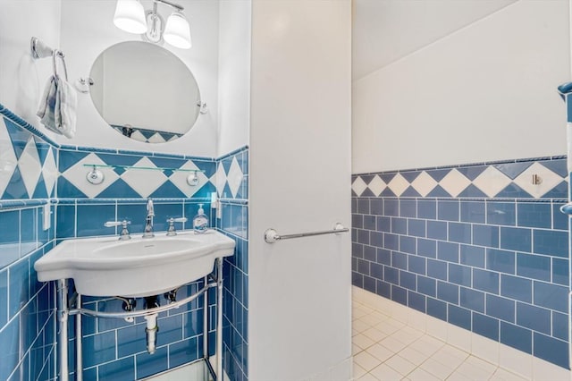 bathroom featuring tile walls, wainscoting, and tile patterned flooring