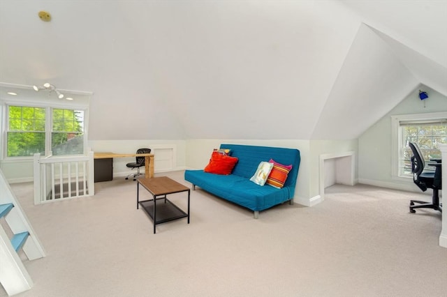 interior space with baseboards, carpet flooring, lofted ceiling, and a wealth of natural light