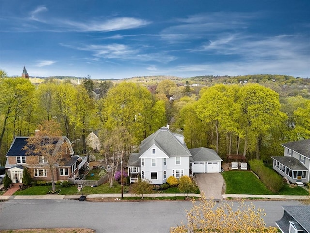 birds eye view of property featuring a view of trees