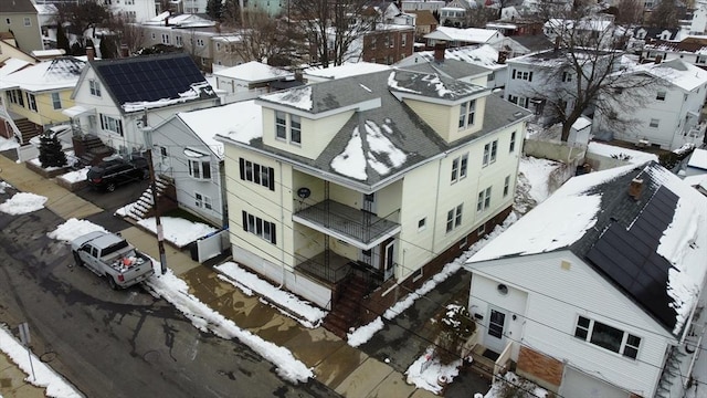 snowy aerial view with a residential view