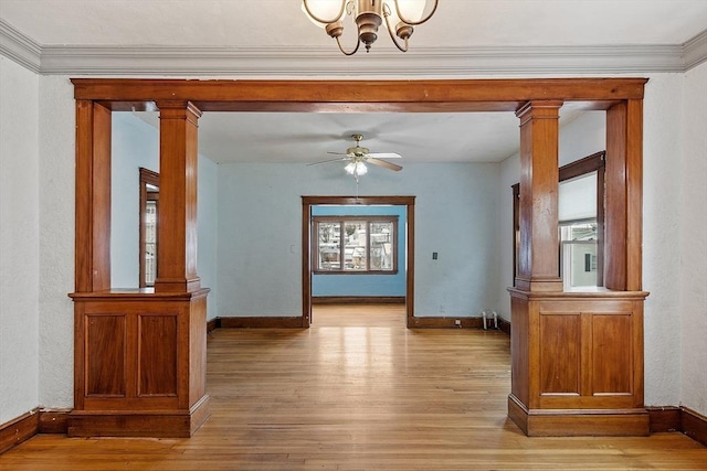 interior space with light wood-style floors, decorative columns, and baseboards