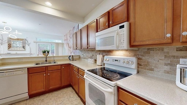 kitchen featuring a sink, light countertops, white appliances, beamed ceiling, and brown cabinetry