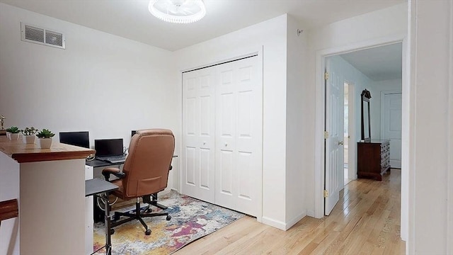 office featuring visible vents, baseboards, and light wood-type flooring