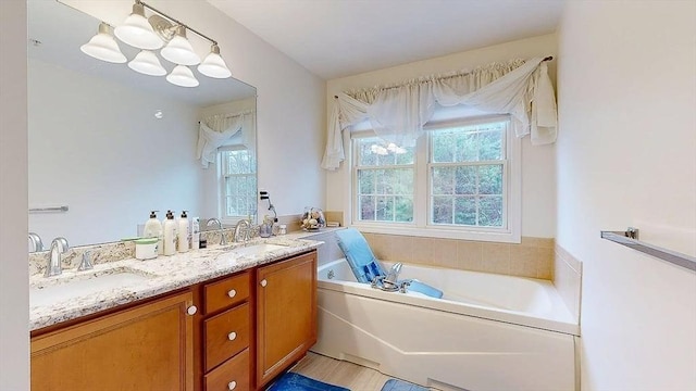 bathroom featuring a sink, double vanity, and a garden tub