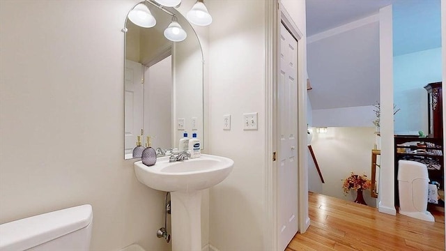 half bath featuring toilet and wood finished floors