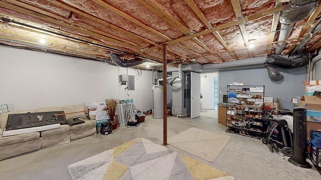 unfinished basement featuring electric panel and gas water heater