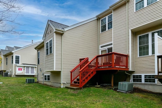 back of property featuring a yard, central AC unit, and stairway