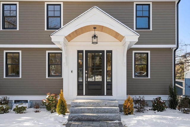 view of snow covered property entrance