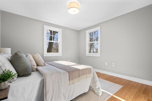 bedroom featuring multiple windows and hardwood / wood-style floors