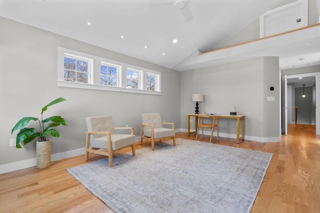 living area with high vaulted ceiling and light wood-type flooring