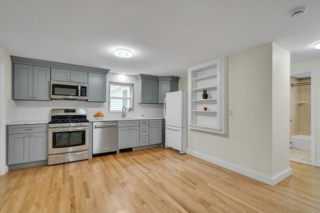 10-12 Spring Rd, Arlington, MA 02476 - kitchen with stainless steel appliances, gray cabinets, light wood-type flooring, and light countertops