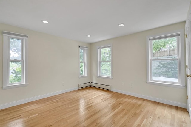 10-12 Spring Rd, Arlington, MA 02476 - empty room featuring a baseboard radiator, healthy amount of natural light, light wood-type flooring, and recessed lighting